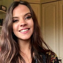 Sophie Flint. She has long brown hair and is smiling.